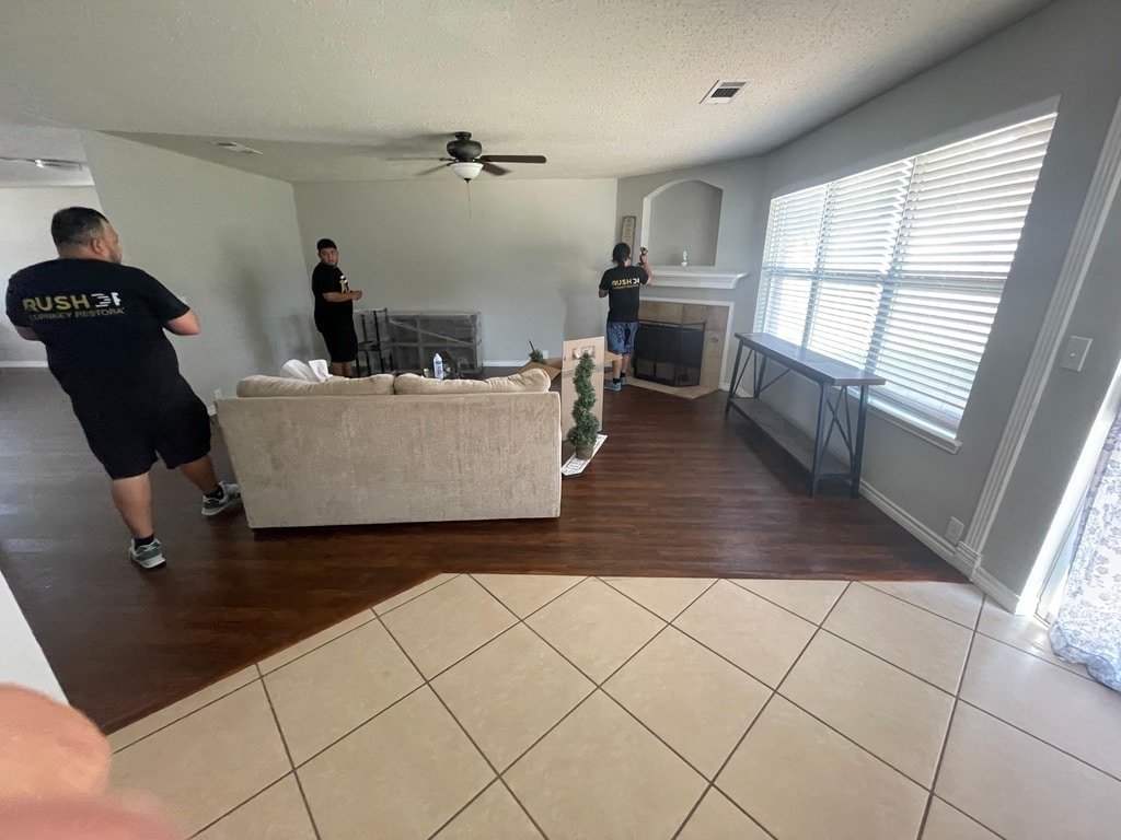 Living room with three people present.