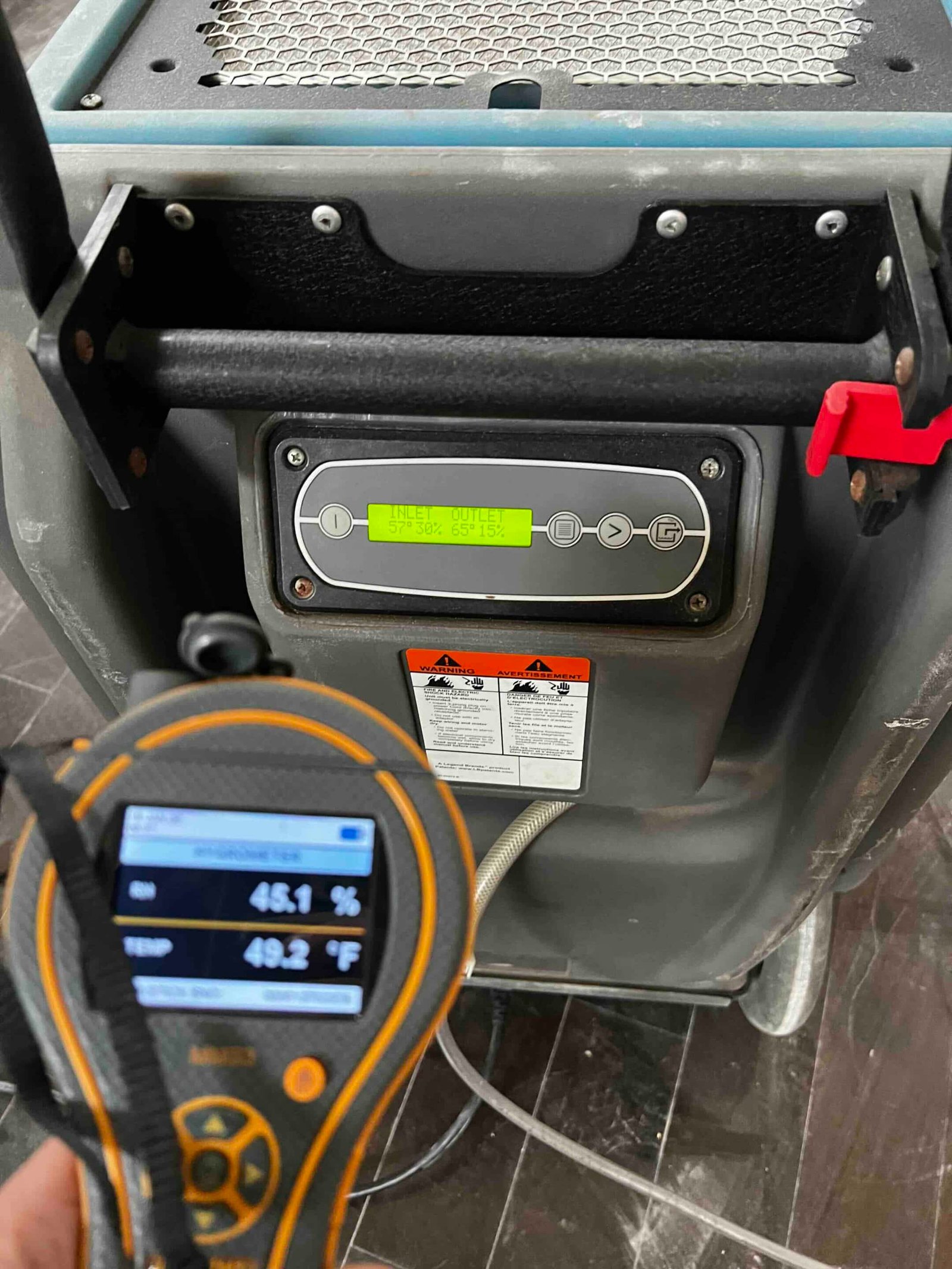 Moisture meter reading during water damage restoration in Dallas