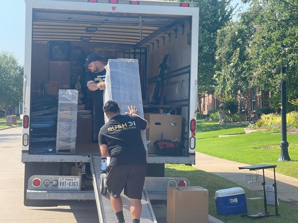 Local emergency restoration technicians loading equipment for a residential job in the Dallas–Fort Worth area