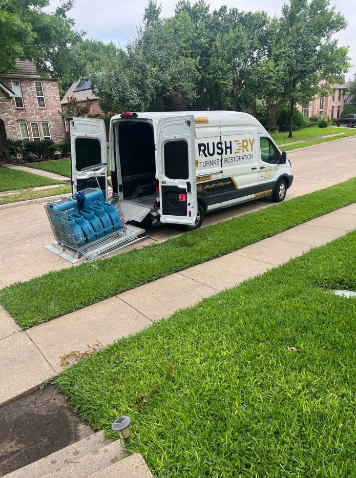 Water damage restoration equipment deployed from a Rush Dry Restoration vehicle in Dallas, Texas