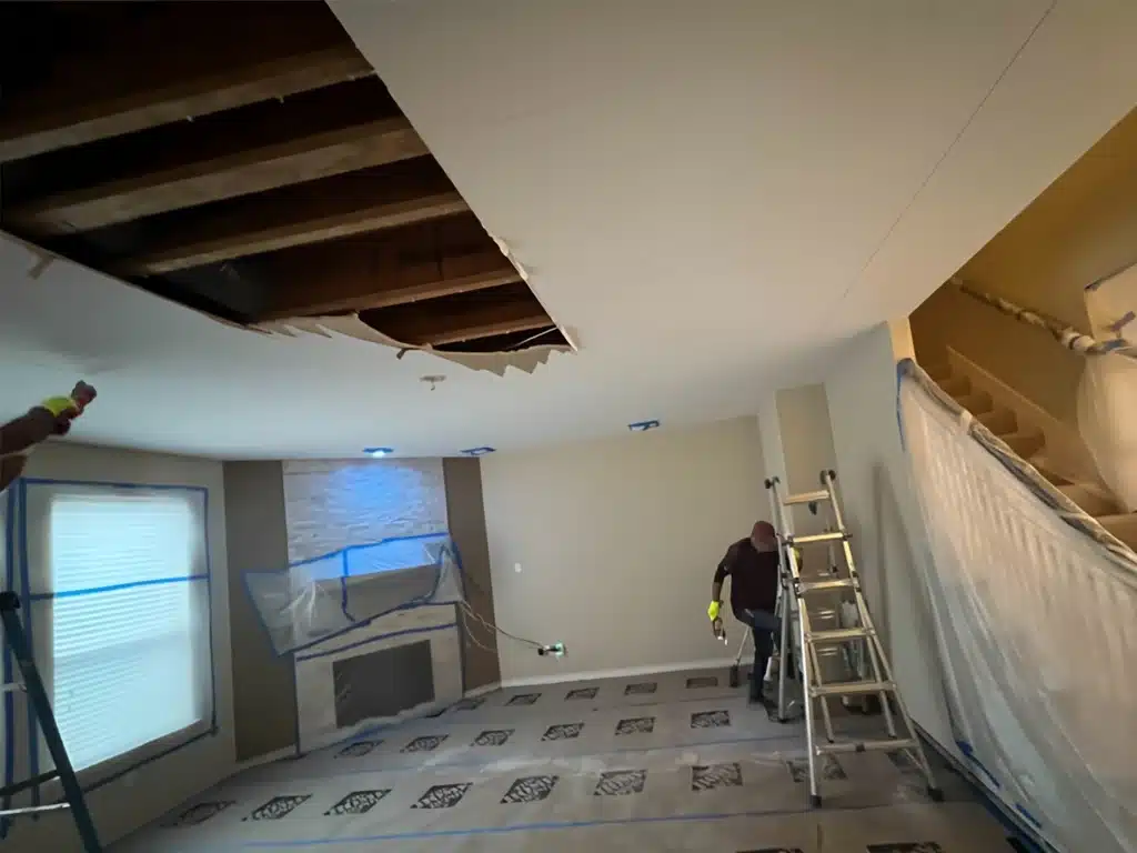 Ceiling water damage repair by Rush Dry team member in Dallas–Fort Worth with exposed ceiling section