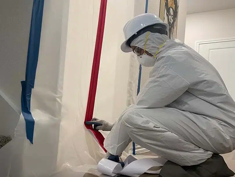 Rush Dry Restoration employee performing mold containment and safety measures during remediation in Frisco, TX