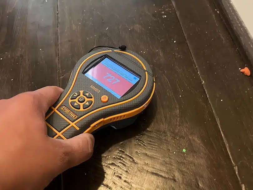Protimeter moisture meter detecting floor moisture during Water Damage Restoration Allen inspection